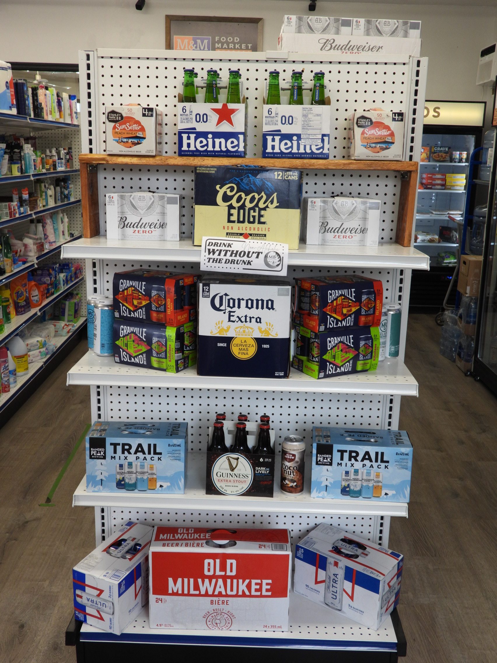 Cases of beer of well known brands arranged at the end of the aisle